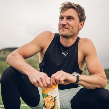 Sportler hockt mit Seeberger Produktpackung in den Händen.